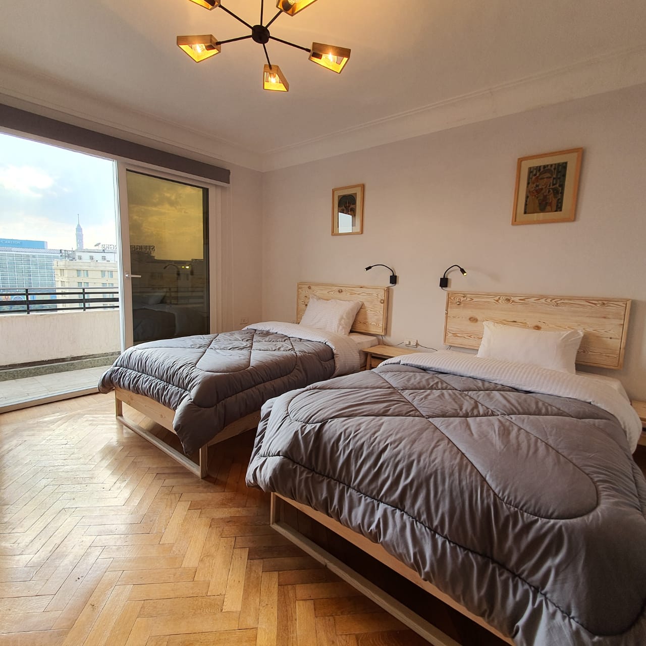 A twin room with two large beds, a private balcony and view over Downtown Cairo.